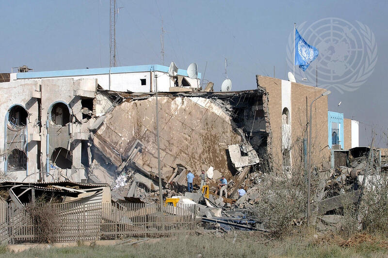 Employees at the United Nations headquarters in Baghdad, Iraq, search through the rubble after an explosion on Tuesday, that killed at least 17 people including the Secretary-General's Special Representative for Iraq, Sergio Vieira de Mello. Some 100 people were reported wounded in the blast. A suicide attacker set off the bomb explosion in a cement truck parked outside the Canal Hotel, which houses the U.N. Headquarters. The United Nations flag is seen at upper right.