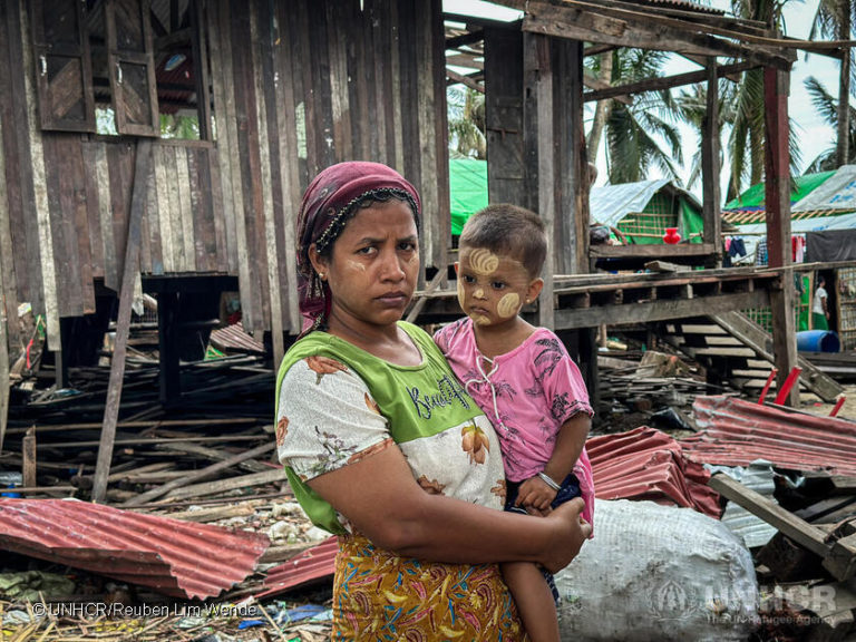 Ma Phyu Ma, a 37-year-old internally displaced Rohingya woman, stands amidst debris left behind by Cyclone Mocha in her village. © UNHCR/Reuben Lim Wende